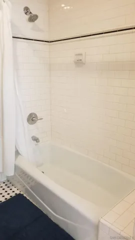 a bathroom with a shower and a bath tub