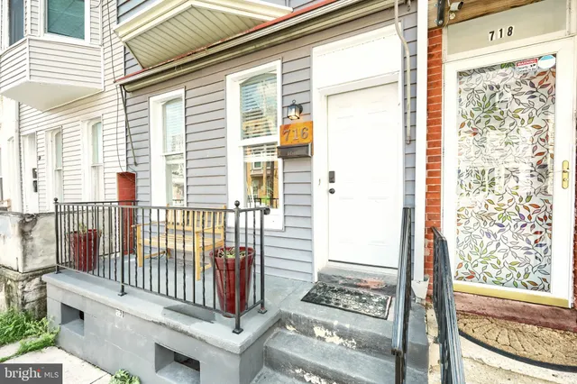 a view of a balcony with wooden floor and iron fence