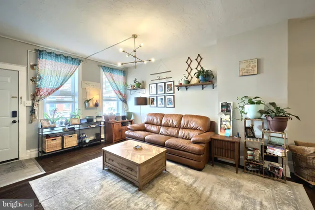 a living room with furniture and a chandelier