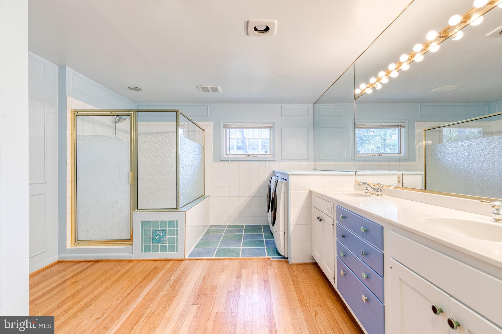 602 Hampton Lane Baltimore, MD 21286 - Photo 24 of 41 a spacious bathroom with a double vanity sink and a large mirror