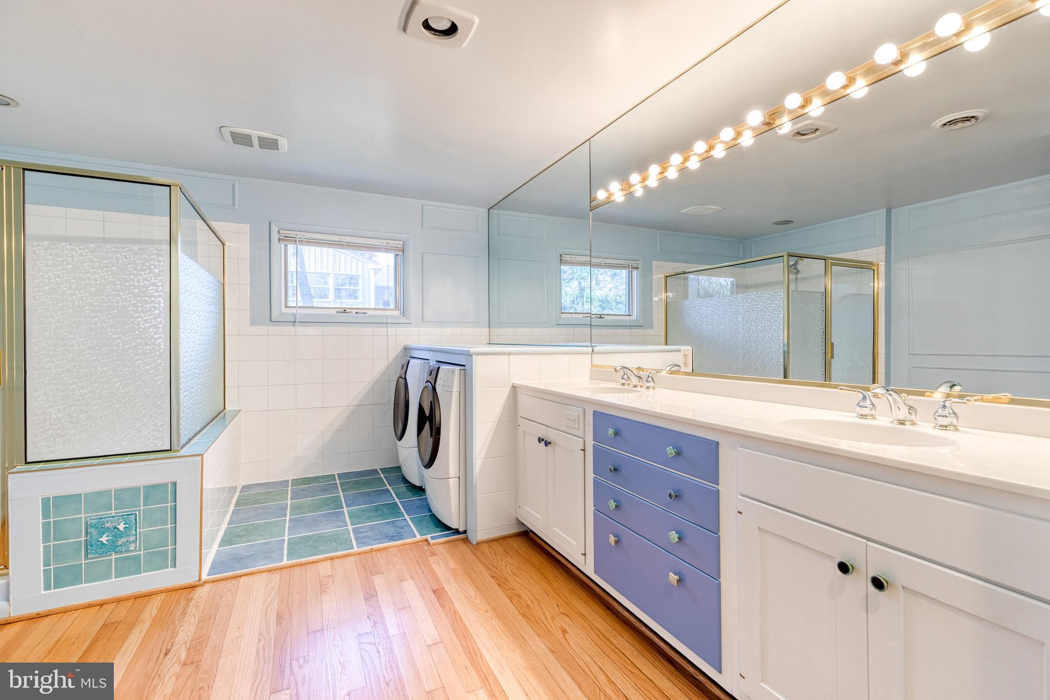 602 Hampton Lane Baltimore, MD 21286 - Photo 25 of 41 a spacious bathroom with a double vanity sink a mirror and a bathtub