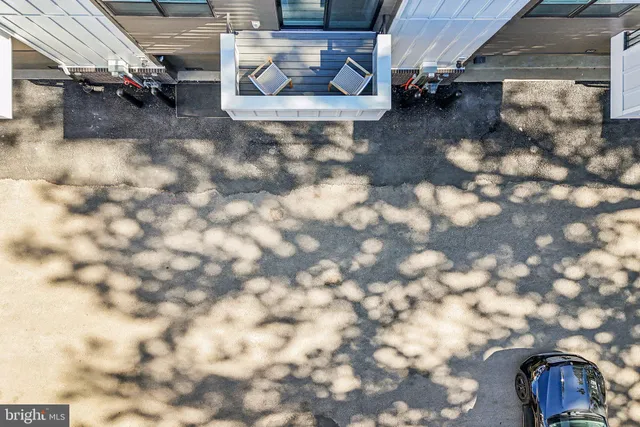 a kitchen with stainless steel appliances kitchen island granite countertop a stove a sink a dining table and chairs with wooden floor