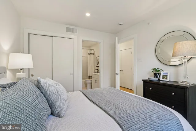 a bed room with a bed and a large window