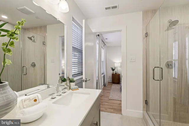 a bedroom with a large bed and a potted plant