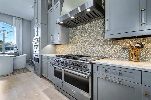 a kitchen with stainless steel appliances granite countertop a stove and a sink
