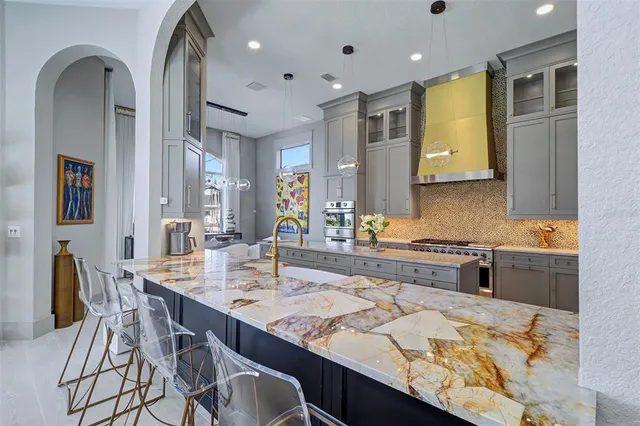 a kitchen with stainless steel appliances granite countertop a sink and cabinets