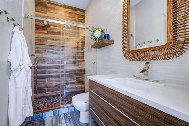 a bathroom with a toilet a sink and a shower