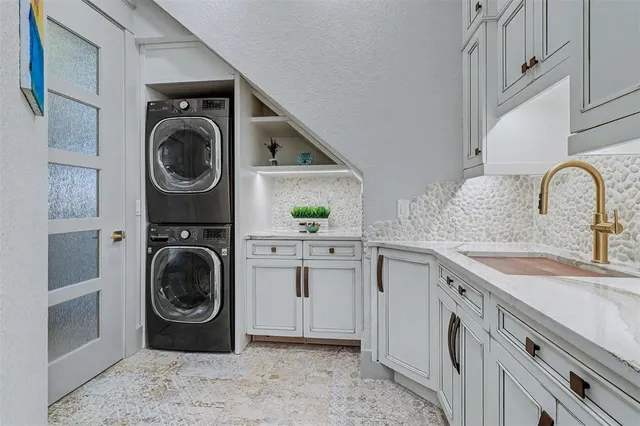 a utility room with sink dryer and washer