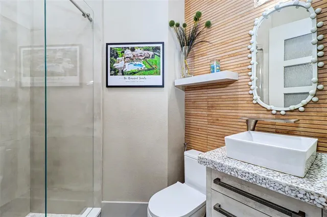 a bathroom with a toilet a sink and mirror