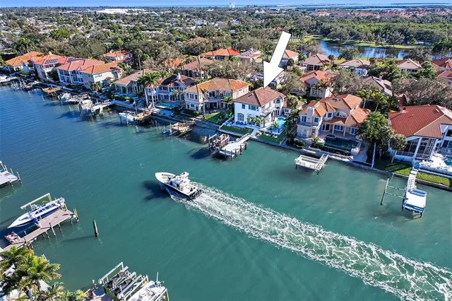 an aerial view of a house with a garden and lake view