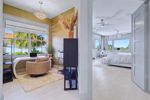 a bedroom with furniture and a large window