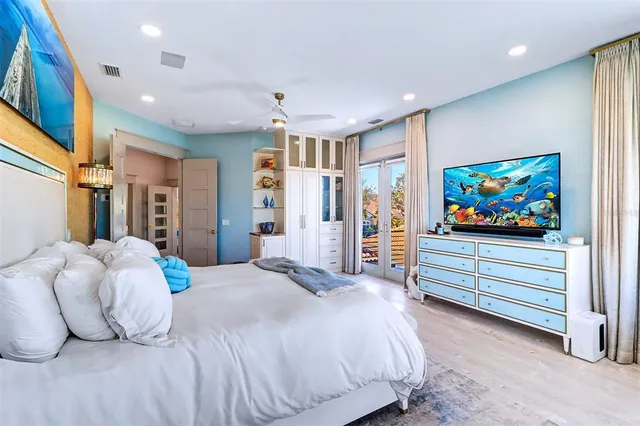 a bedroom with a bed and a flat screen tv