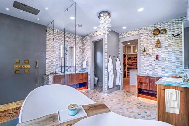 a living room with stainless steel appliances kitchen island granite countertop furniture and a fireplace