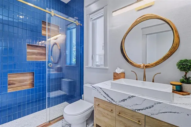 a bathroom with a toilet a sink and mirror