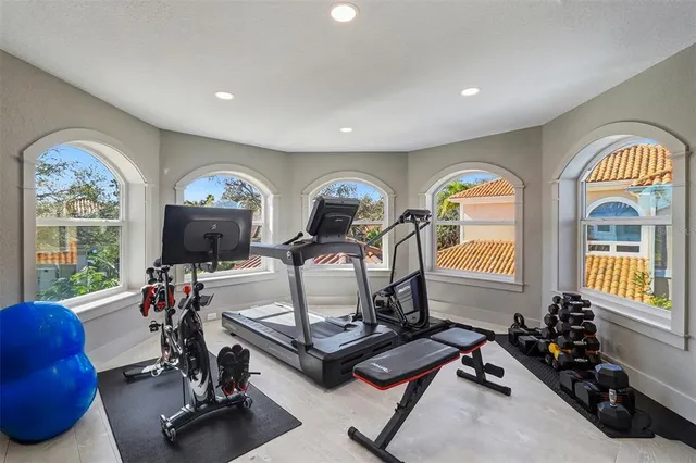 a view of a livingroom with furniture gym equipment and a floor to ceiling window