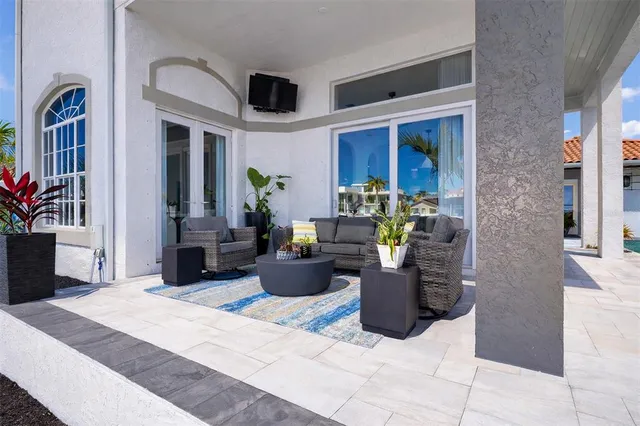 a view of a patio with chairs and potted plants