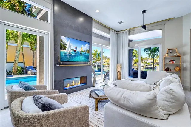 a living room with furniture fireplace and a large window