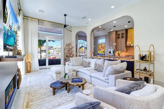 a living room with furniture and a chandelier