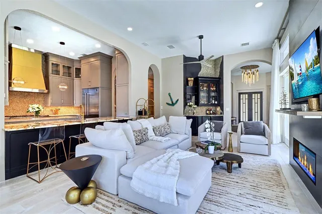 a living room with furniture and a chandelier