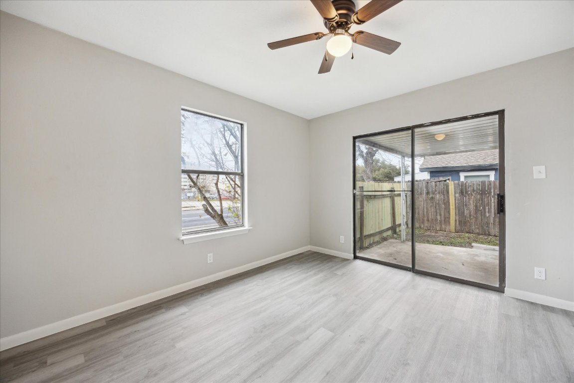 5300 B McCandless Street, Unit B Austin, TX 78756 - Photo 6 of 9 Empty room with baseboards, wood finished floors, and ceiling fan