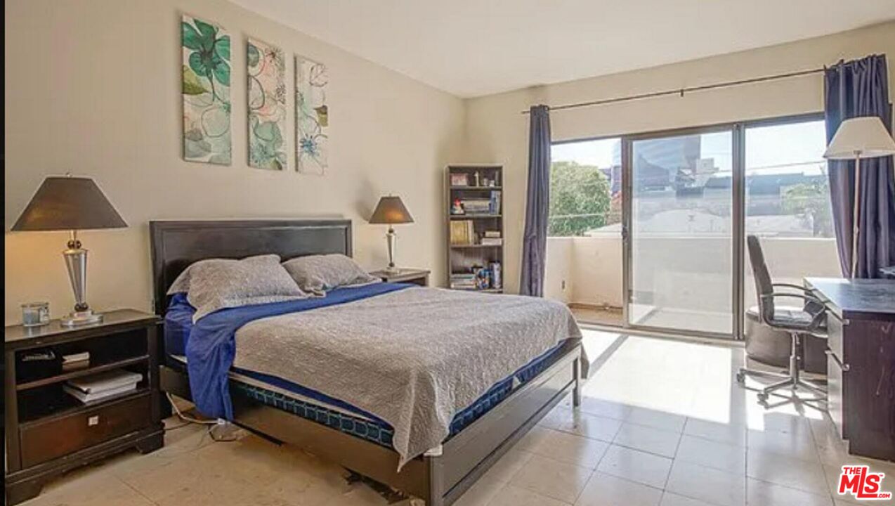 723 Westmount Drive, Unit 203 West Hollywood, CA 90069 - Photo 11 of 17 a bedroom with a bed and a large window