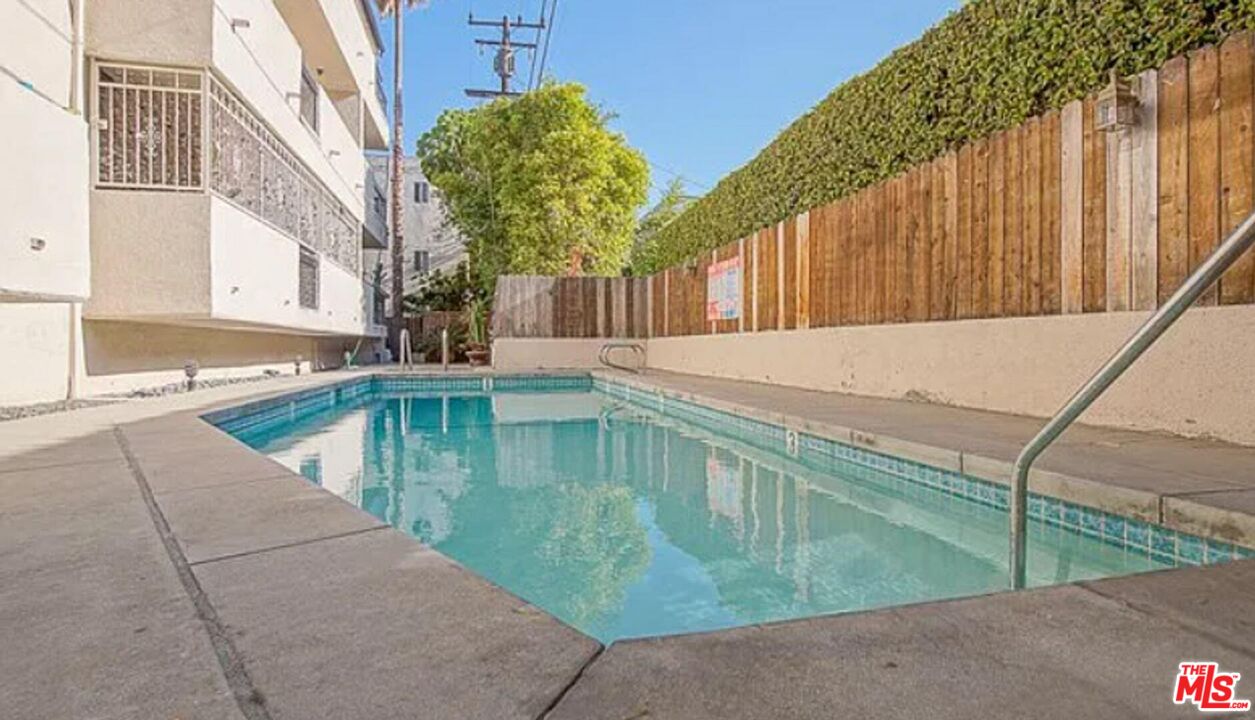 723 Westmount Drive, Unit 203 West Hollywood, CA 90069 - Photo 12 of 17 a view of a swimming pool with a patio