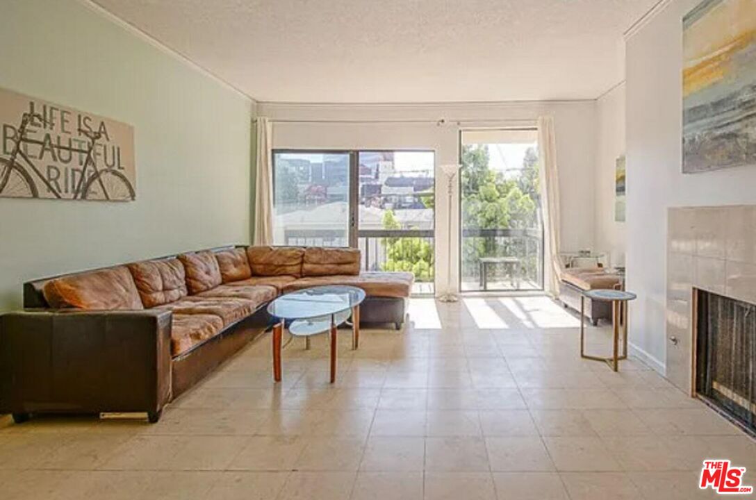 723 Westmount Drive, Unit 203 West Hollywood, CA 90069 - Photo 2 of 17 a living room with furniture and a fireplace