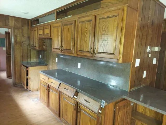 a kitchen with stainless steel appliances granite countertop a sink and cabinets