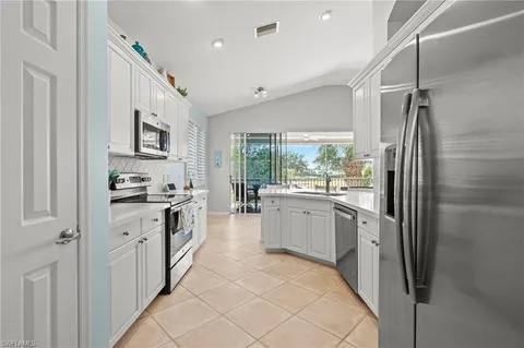 a dining room with furniture a chandelier and wooden floor