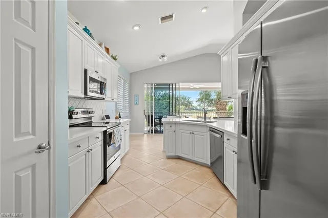 a dining room with furniture a chandelier and wooden floor