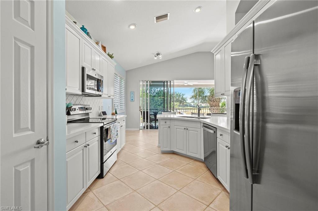 10422 Autumn Breeze Drive, Unit 201 Estero, FL 34135 - Photo 12 of 34 a kitchen with a refrigerator and a sink