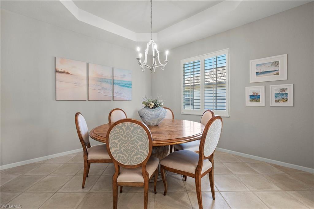 10422 Autumn Breeze Drive, Unit 201 Estero, FL 34135 - Photo 14 of 34 a view of a dining room with furniture window and wooden floor