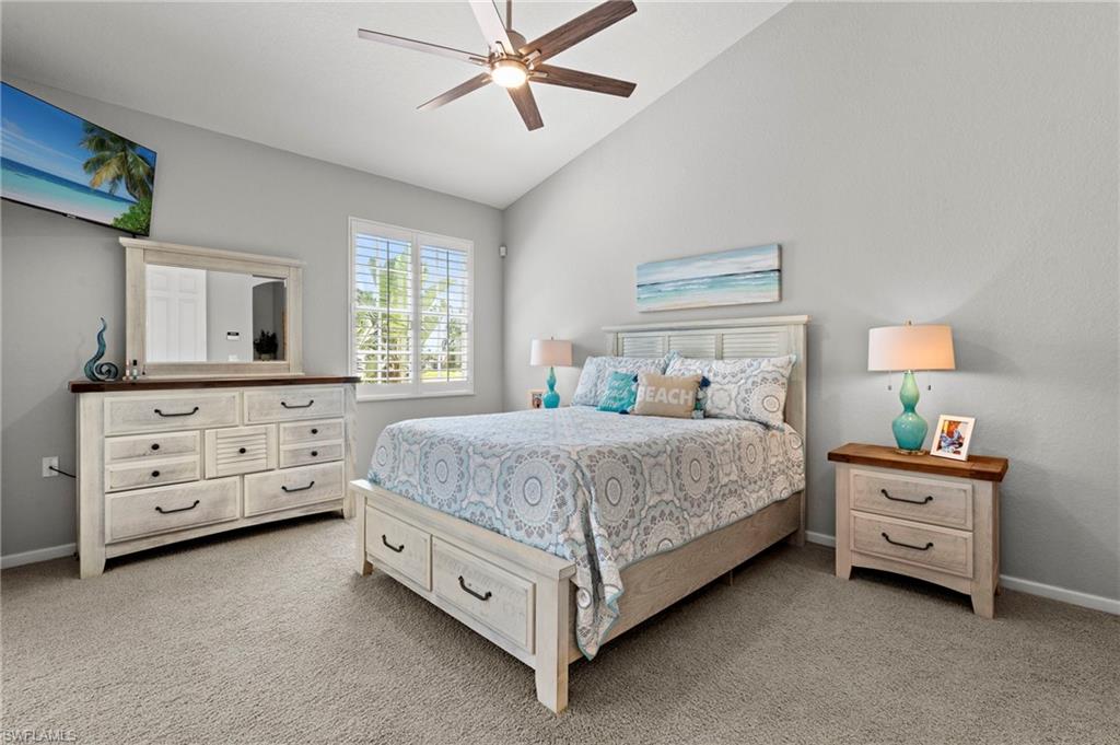 10422 Autumn Breeze Drive, Unit 201 Estero, FL 34135 - Photo 15 of 34 a spacious bedroom with a bed and a chandelier