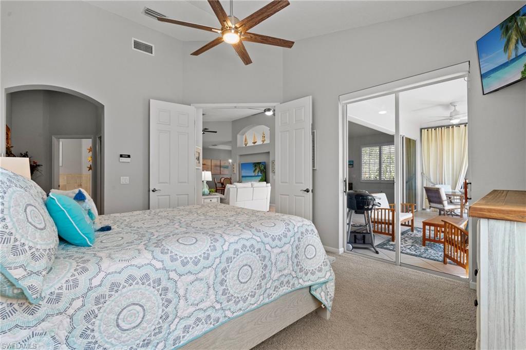 10422 Autumn Breeze Drive, Unit 201 Estero, FL 34135 - Photo 16 of 34 a bedroom with a bed and a mirror