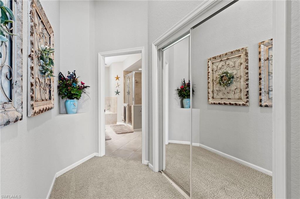 10422 Autumn Breeze Drive, Unit 201 Estero, FL 34135 - Photo 18 of 34 a view of a hallway with paintings on the wall