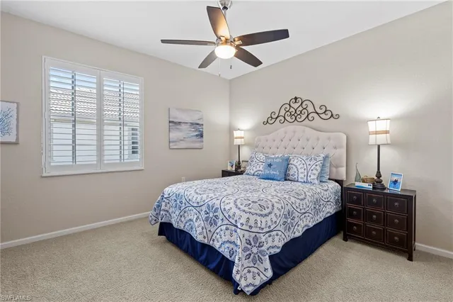 a bedroom with a bed and ceiling fan