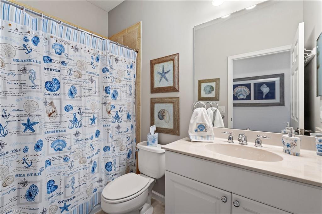 10422 Autumn Breeze Drive, Unit 201 Estero, FL 34135 - Photo 26 of 34 a bathroom with a sink toilet and shower