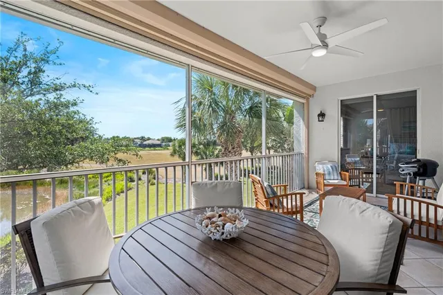a view of a dining room with furniture a chandelier and wooden floor