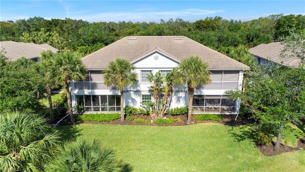 10422 Autumn Breeze Drive, Unit 201 Estero, FL 34135 - Photo 32 of 34 an aerial view of a house with a garden and trees
