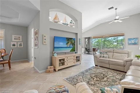 a living room with furniture a dining table and a fireplace
