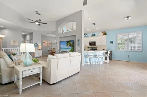 a living room with lots of furniture and kitchen view