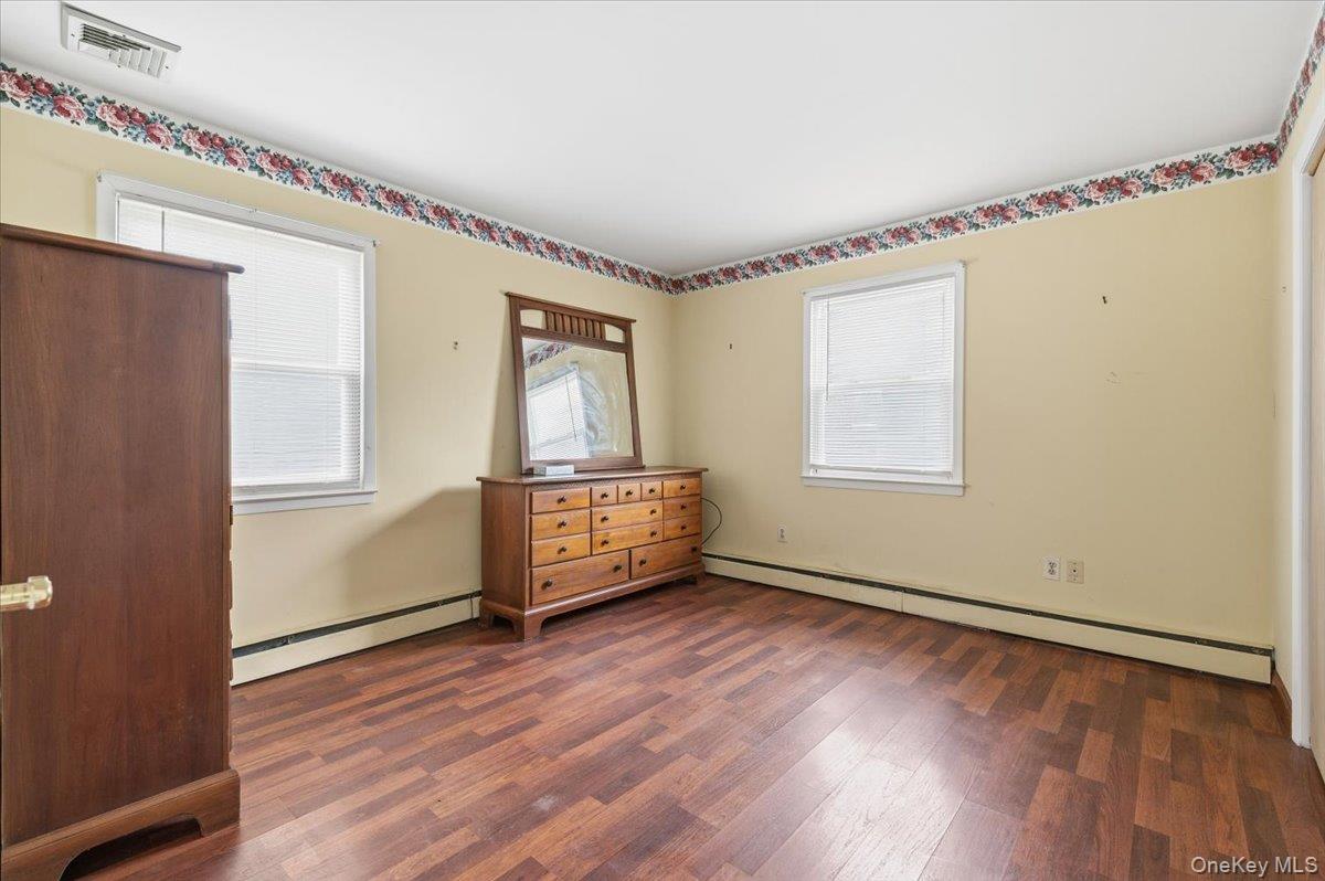 13 Jean Road West Islip, NY 11795 - Photo 11 of 25 a view of empty room with wooden floor and fan