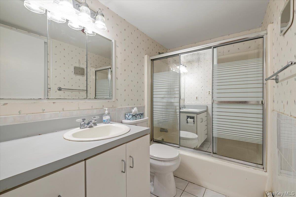 13 Jean Road West Islip, NY 11795 - Photo 13 of 25 a bathroom with a sink a toilet and shower