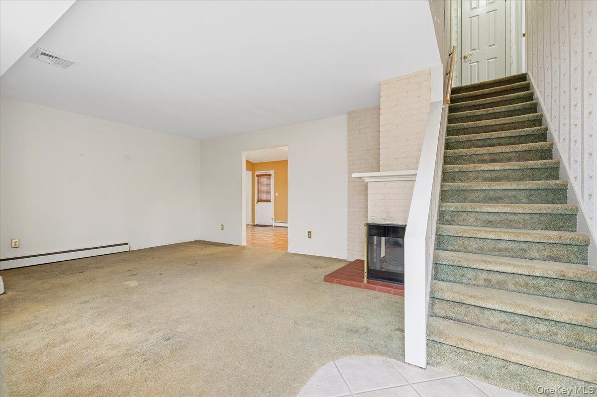 13 Jean Road West Islip, NY 11795 - Photo 5 of 25 a view of an empty room with a fireplace