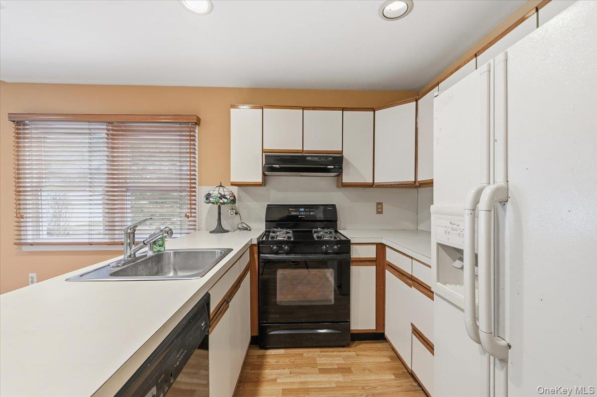 13 Jean Road West Islip, NY 11795 - Photo 10 of 25 a kitchen with a sink stove top oven and refrigerator