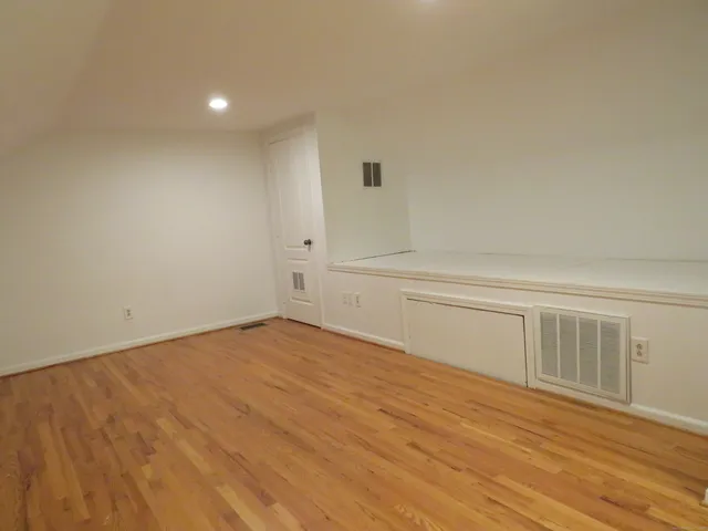 a view of an empty room and wooden floor
