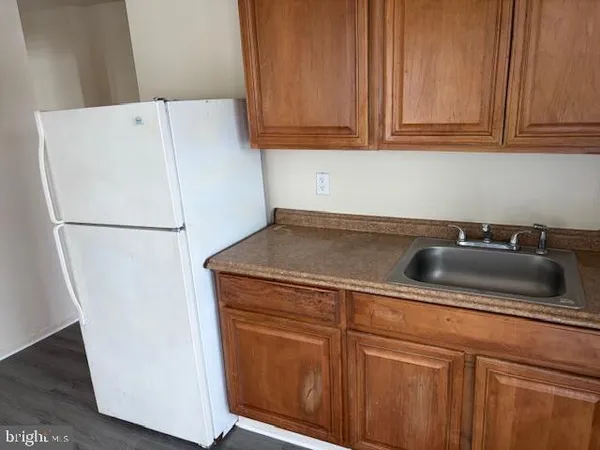 a kitchen with a refrigerator and cabinets