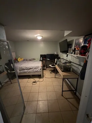 a bedroom with furniture and a air conditioner vent