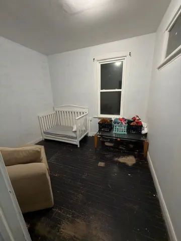 a bedroom with bed and a window