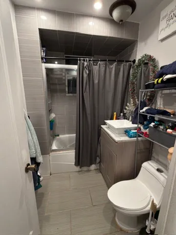 a bathroom with a toilet and a shower